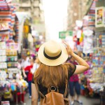 best asian countries to visit - woman walking through a busy market