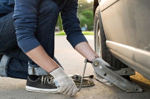 car care - mechanic putting the car on a lift