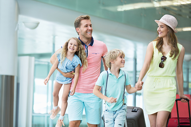 family traveling together through an airport