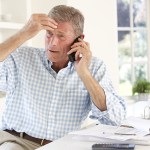 man stressed over the phone about completing a life insurance claim