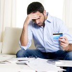man is frustrated with credit card debt