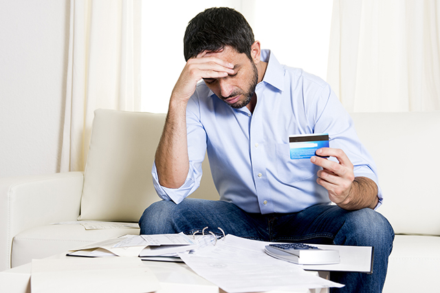 man is frustrated with credit card debt