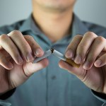 smoker life insurance - man breaking a cigarette