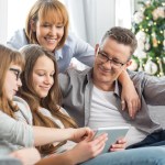 family huddled together using a tablet