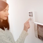 woman setting her home security alarm