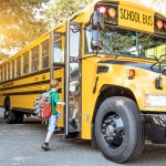 young kid boarding a school bus - when to stop for a school bus