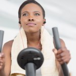 woman working out on a treadmill listening to music