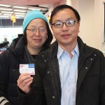 Paul Lee and Mimi Man at the Garden City, N.Y., branch, holding a membership card.