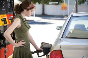 Woman putting gas in car