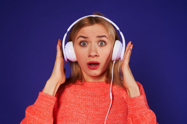 halloween podcast - girl listening to podcasts with headphones