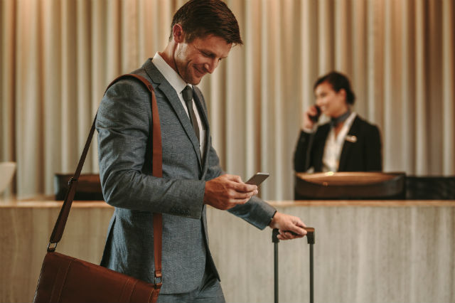 hotel tech - guest using his smartphone