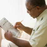 man doing crossword puzzle