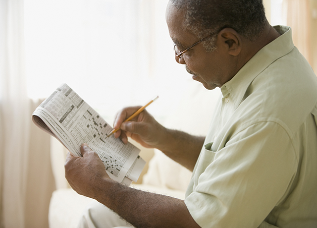 man doing crossword puzzle
