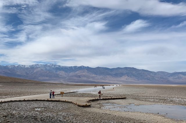People walking a path through a salt flat