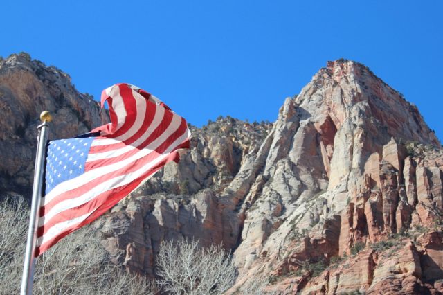 American flag against cliff background