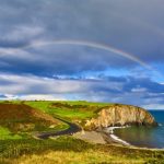 the best time to visit ireland to avoid crowds - copper coast with rainbow