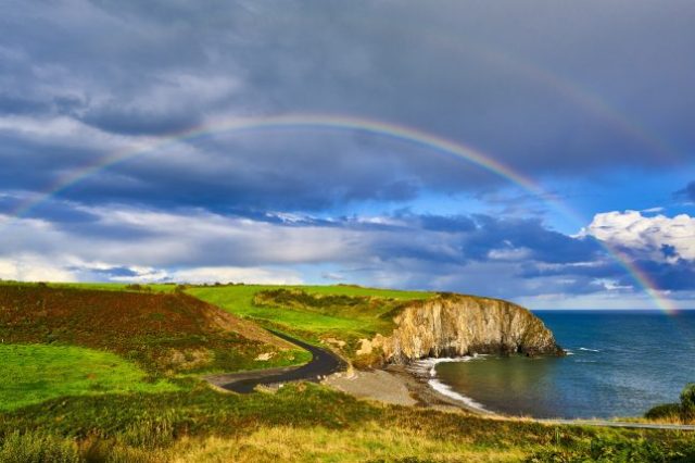the best time to visit ireland to avoid crowds - copper coast with rainbow