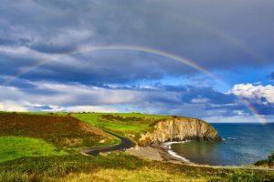 the best time to visit ireland to avoid crowds - copper coast with rainbow