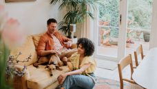 how to save on life insurance - couple on couch with dog