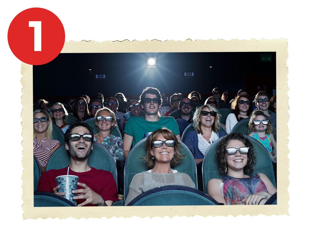 People watching a screen at the movies