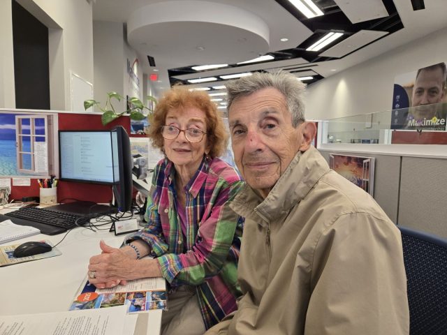 Karen and Simon Landsman finalizing trip plans at the Garden City, New York, branch.