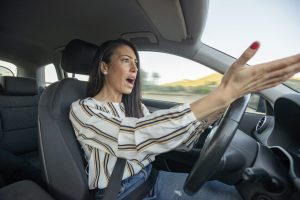 Angry and frustrated Woman Driving Car