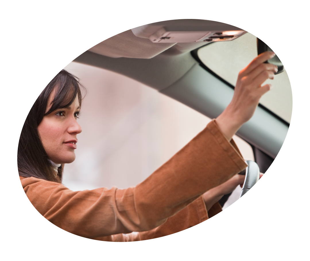 Person looking in rear view mirror