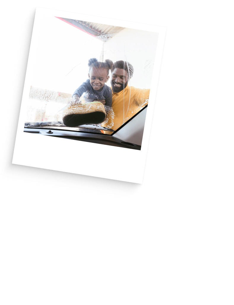 Father and daughter washing car